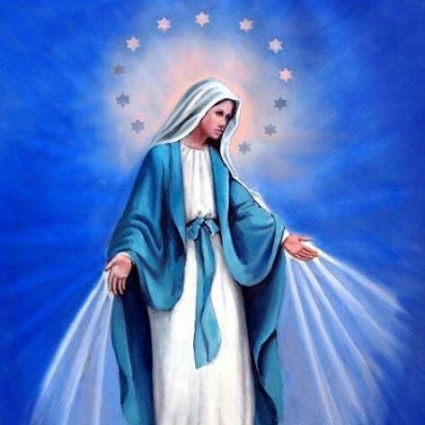 A photo of the Virgin Mary wearing a white and blue dress with a halo of stars around her head.